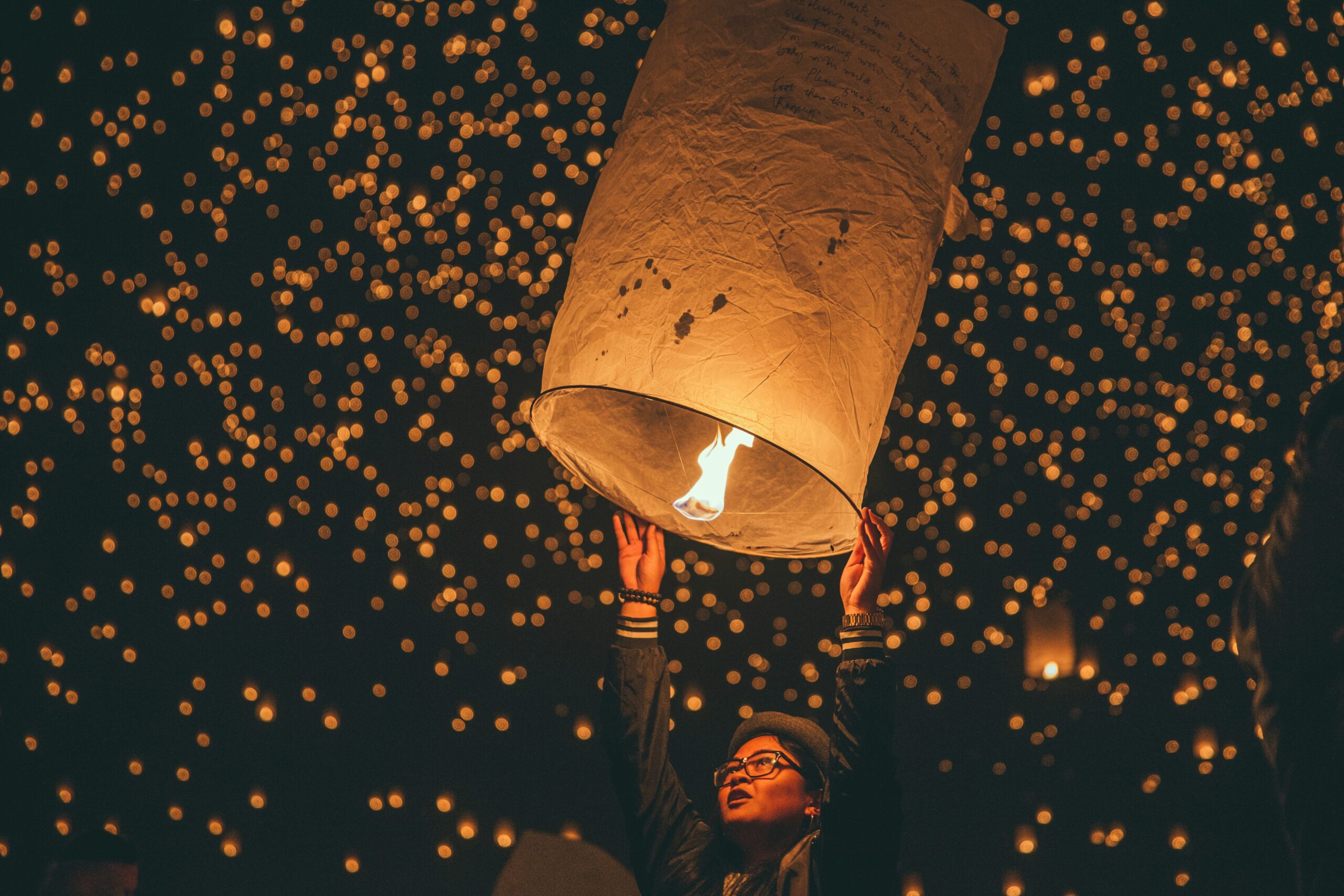 Chinese lantern festival, hundreds of lanterns rising in the night sky.